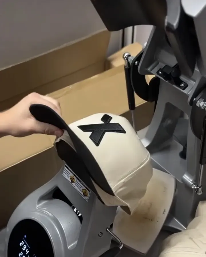 A Lift Threadz Promos team member loading a cream and black hat into a heat press.